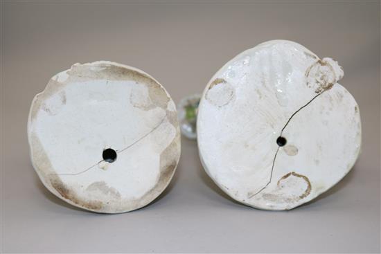 A pair of Derby candlestick figures of a gentleman and a lady, 24cm, damaged